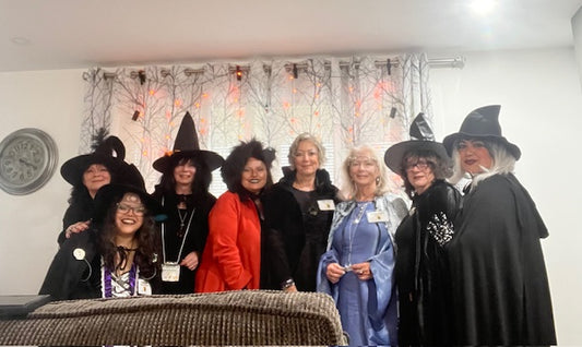 Group of ladies wearing witch costumes at our Halloween Afternoon murder mystery tea.