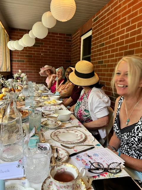 Women enjoying Afternoon tea at Darcys Tea Circle, overlooking the woods.